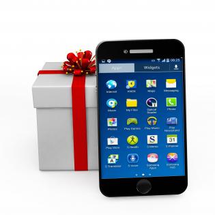 Mobile phone with gift box showing phone as gift stock photo