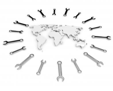 White world map surrounded with multiple wrenches stock photo